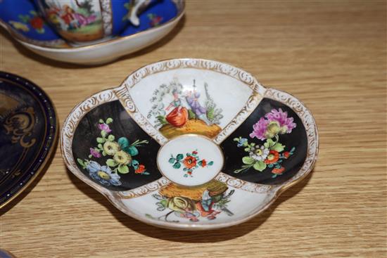 A group of Dresden cup saucers and covers, a Russian tea cup and other Continental porcelain cups